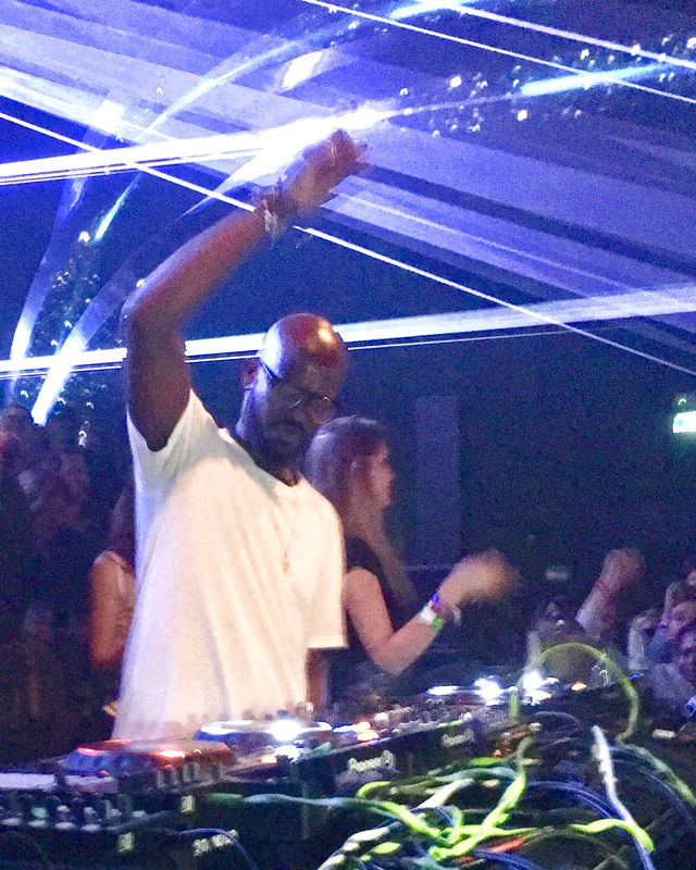 Black Coffee behind the decks under blue lasers