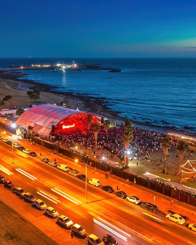 Aerial view of a Boris Brejcha show on the Montevideo waterfront at dusk