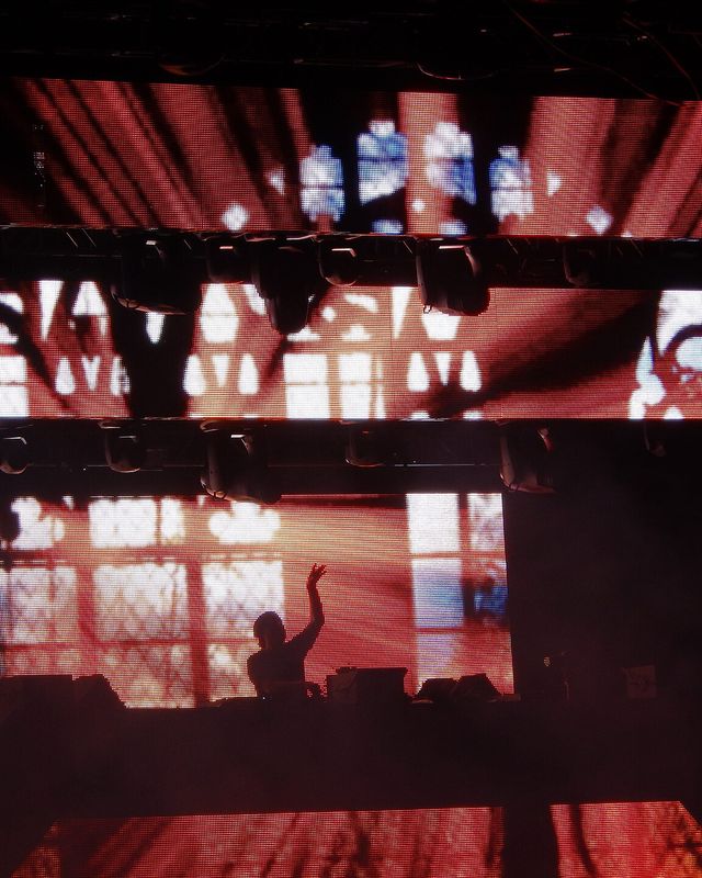 Eric Prydz's stage lit red behind a lighting rig