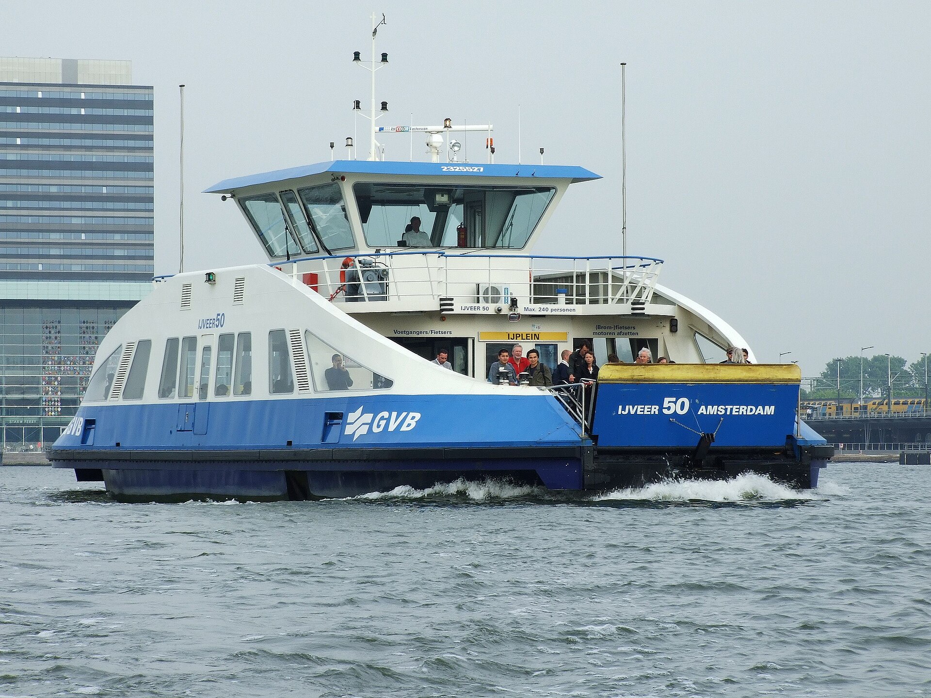 A free GVB ferry crossing the IJ behind Amsterdam Centraal