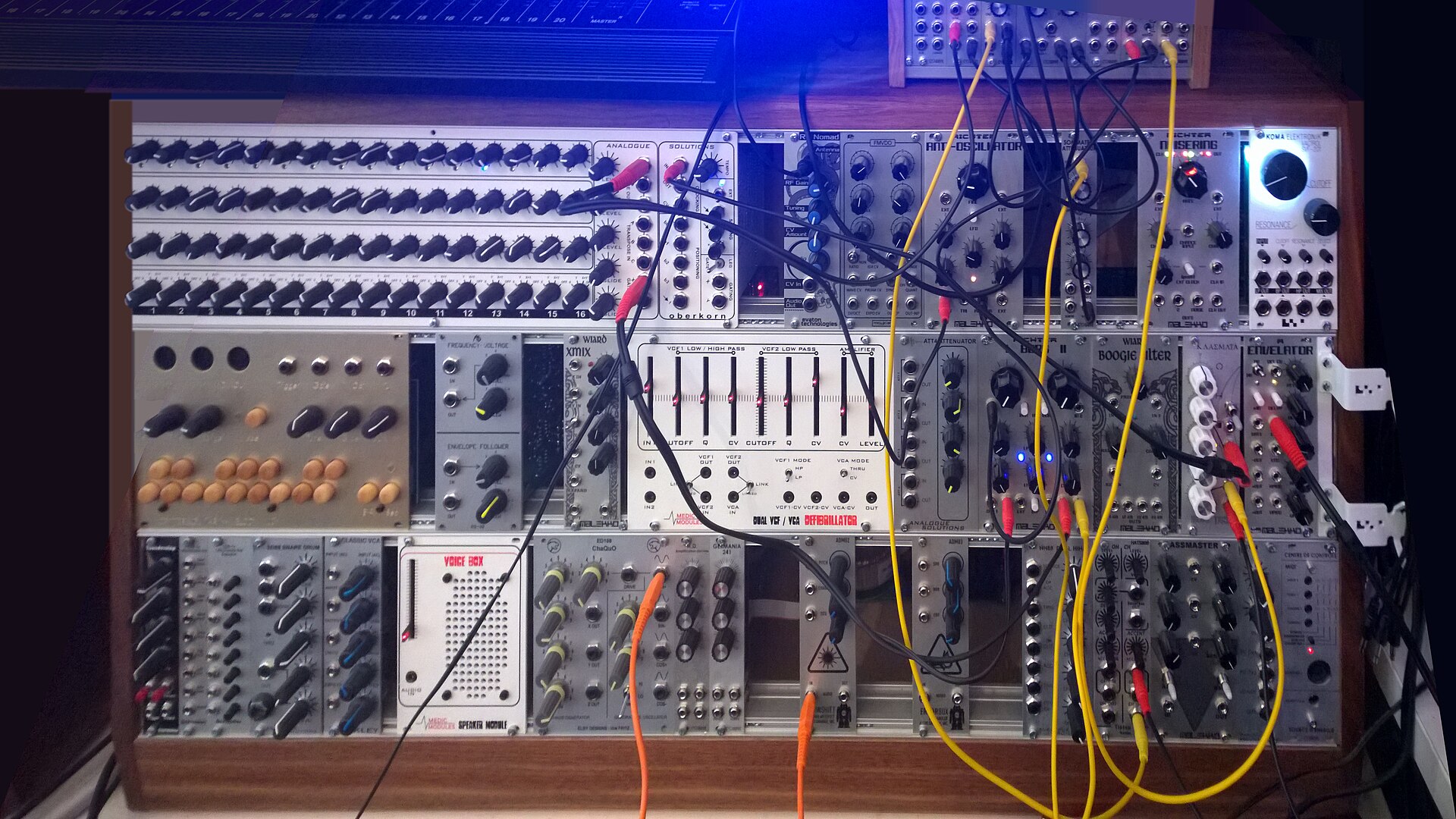 A large modular synthesizer covered in patch cables